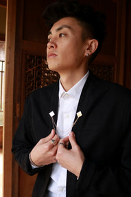 Technical Black Noragi Jacket elevated with Akashi Kama traditional Himo-inspired brooch and mens white button-up shirt