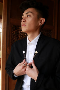 Technical Black Noragi Jacket elevated with Akashi Kama traditional Himo-inspired brooch and mens white button-up shirt