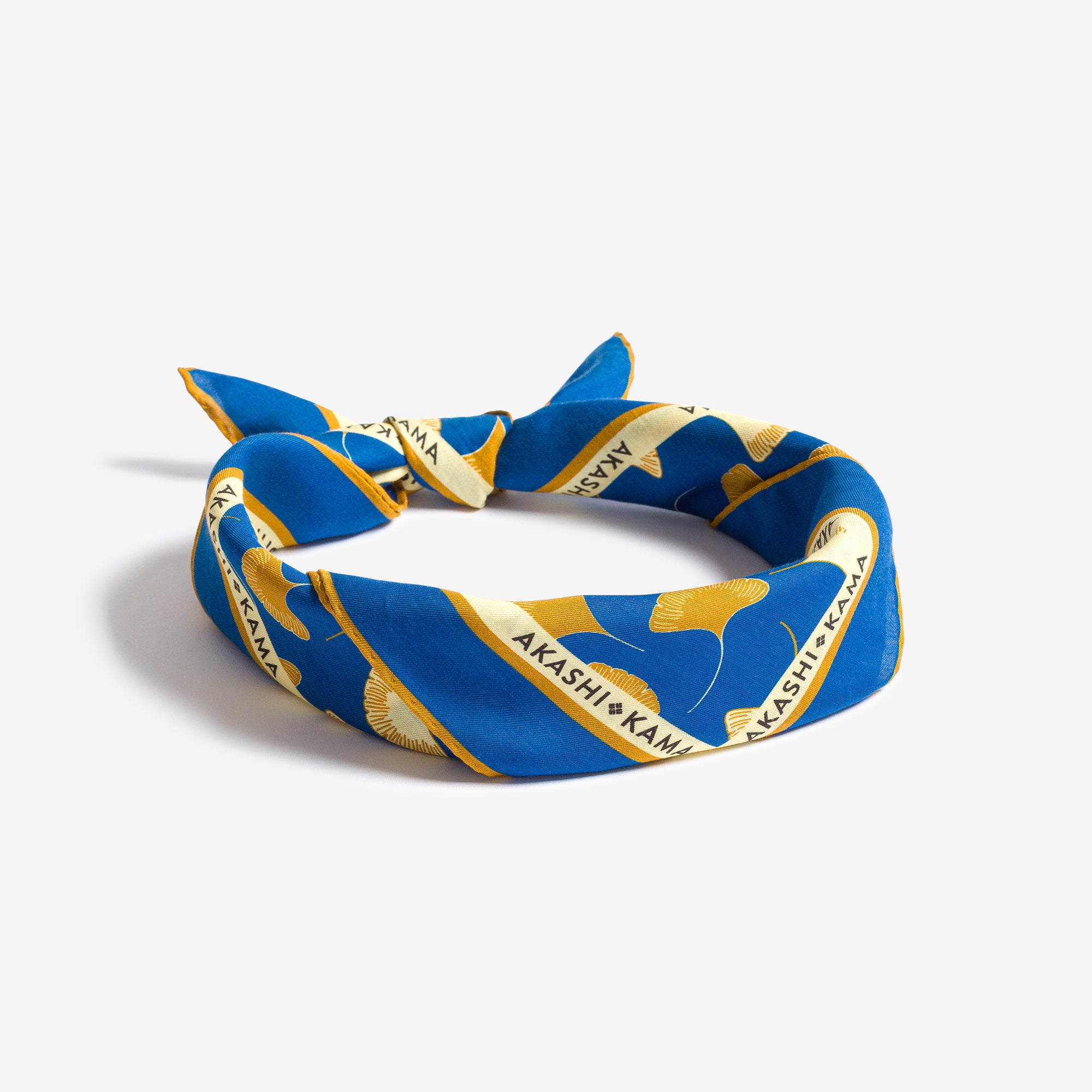Japanese Ginkgo Leaf silk-cotton blue bandana folded for neck scarf styling,
craftsmanship blending European and Japanese influence, made in Italy 
