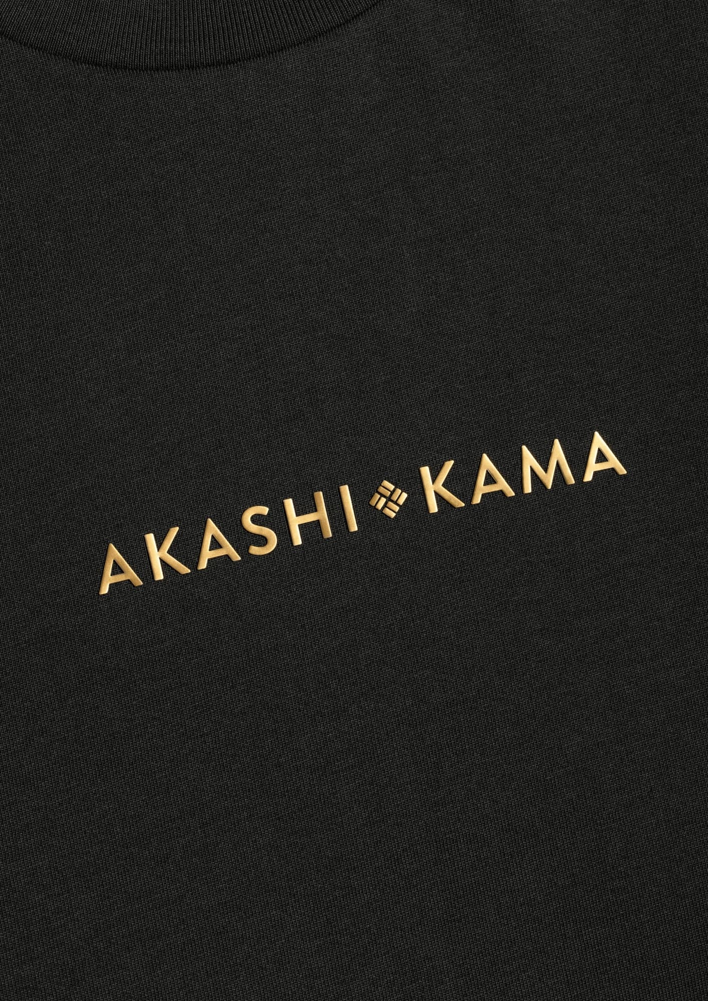 Metallic gold 3D silicon stamped logo on AKASHI-KAMA Charcoal tee