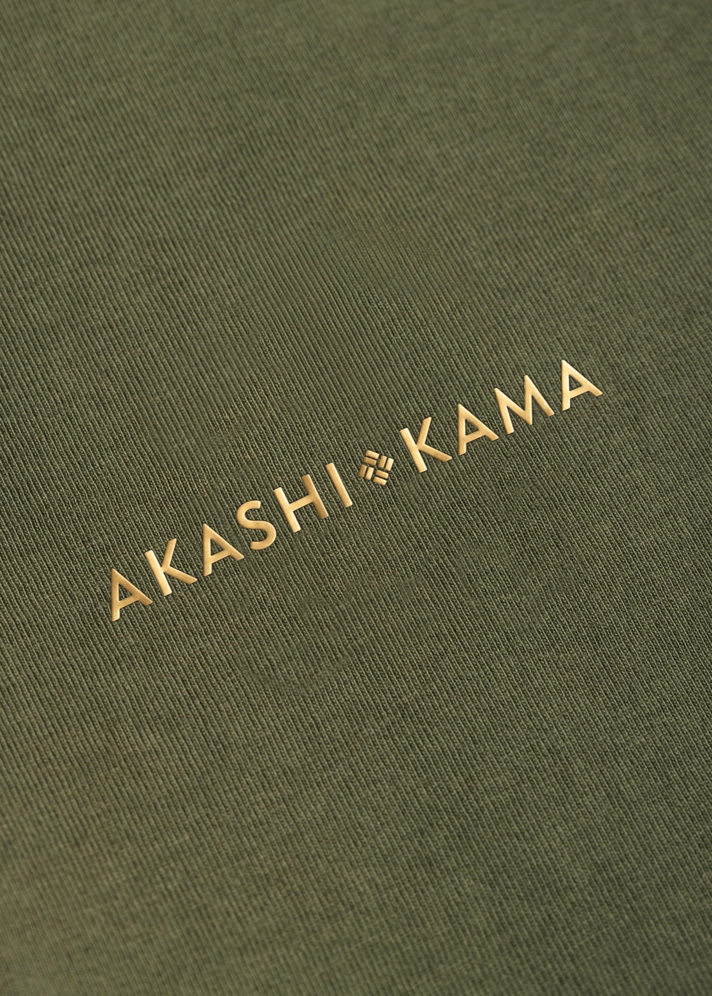 Metallic gold 3D silicon stamped logo on AKASHI-KAMA Olive tee