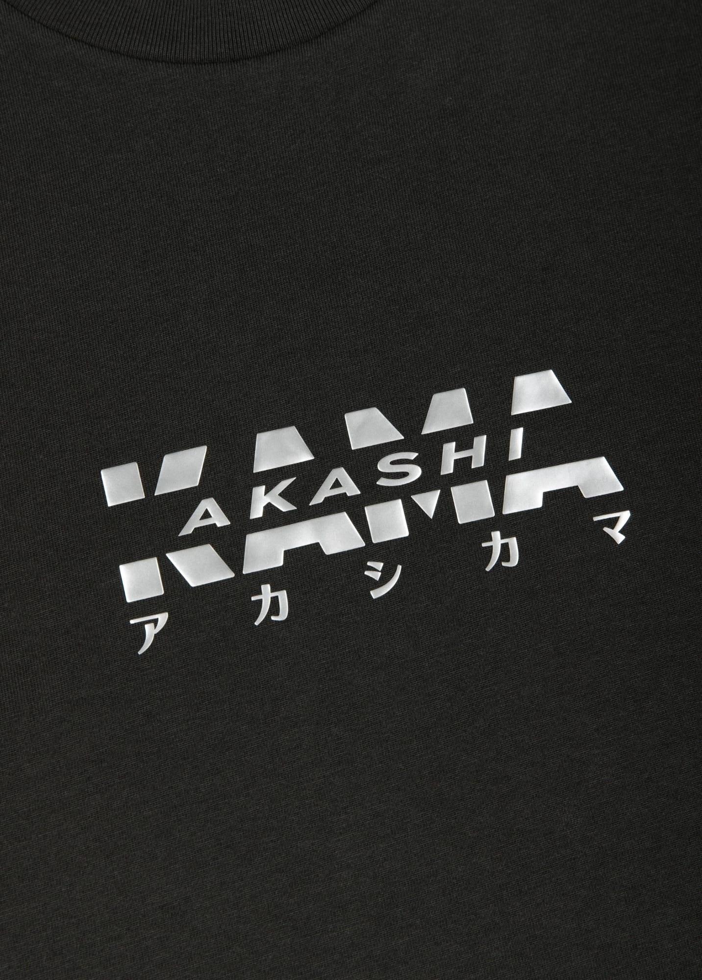 Metallic silver 3D silicon track logo on AKASHI-KAMA Charcoal tee
