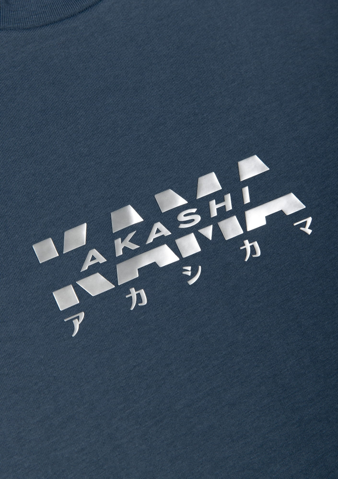 Metallic silver 3D silicon track logo on AKASHI-KAMA Koi Blue tee