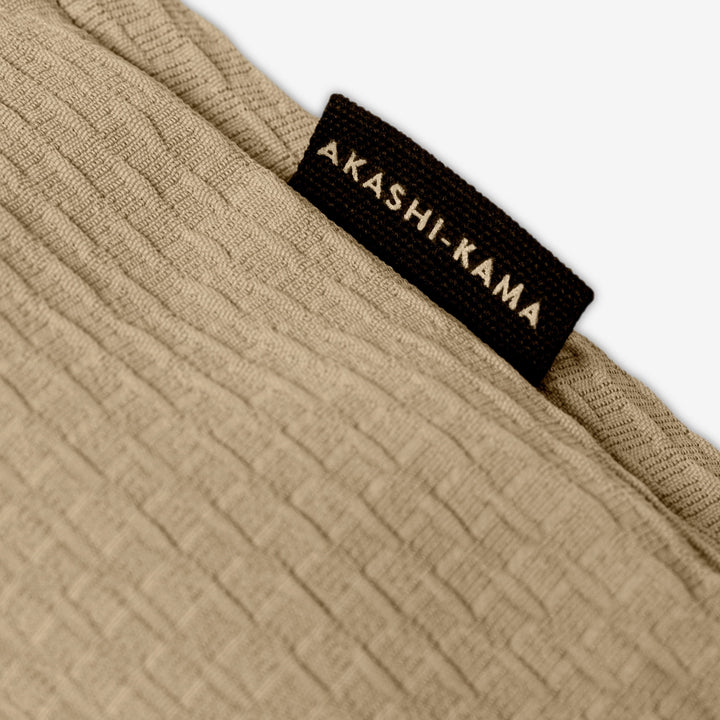 AKASHI-KAMA side label on beige textured Technical Sashi Clay tailored shorts