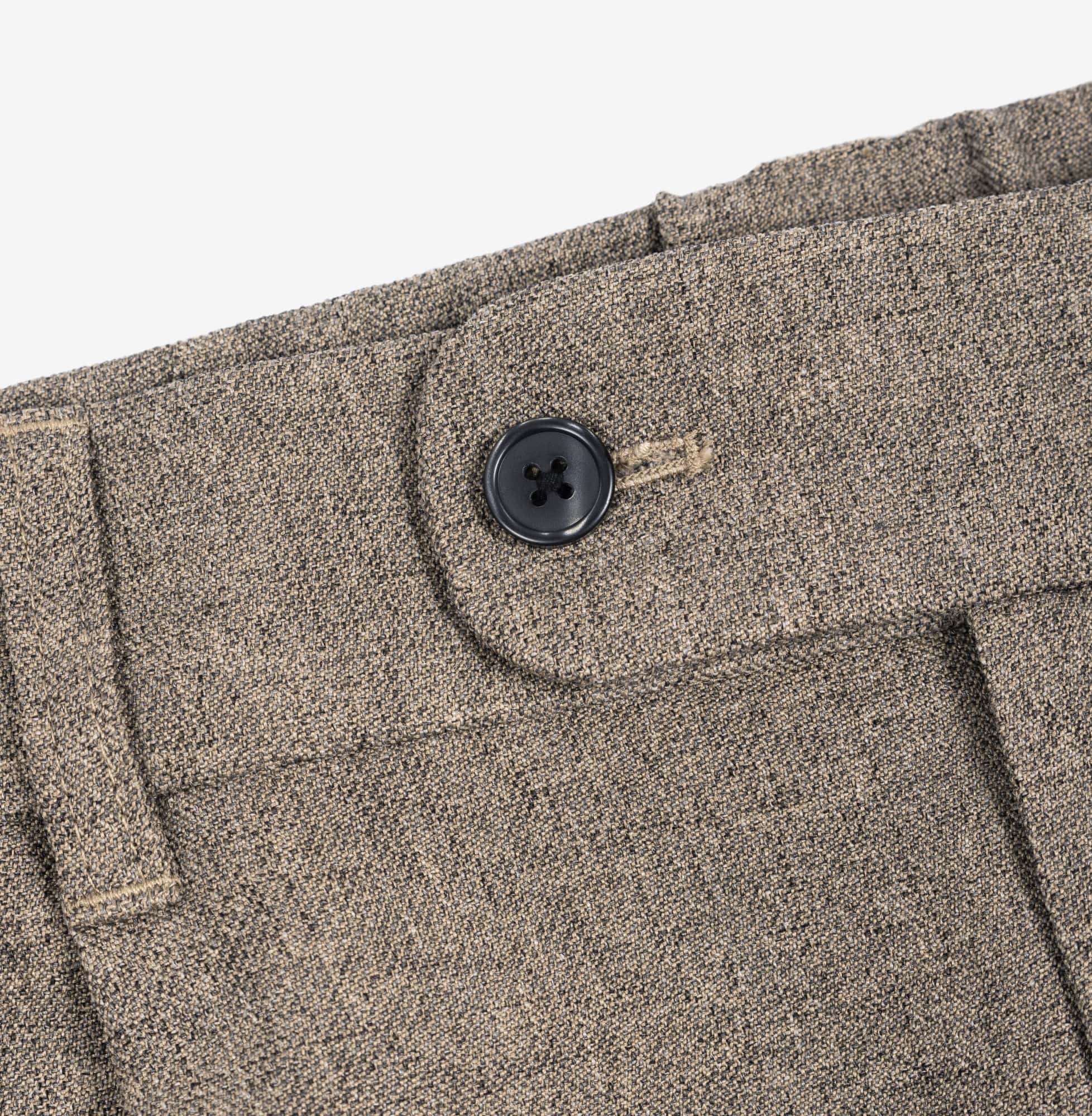 AKASHI-KAMA Mocha Taupe pleated trousers showing black button closure and textured waistband